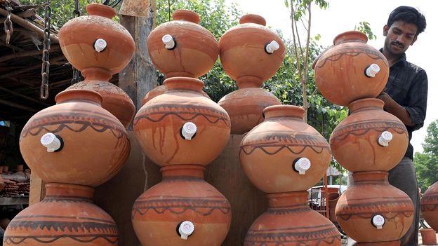 Getty Images Man standing with terracotta pots (Credit: Getty Images)